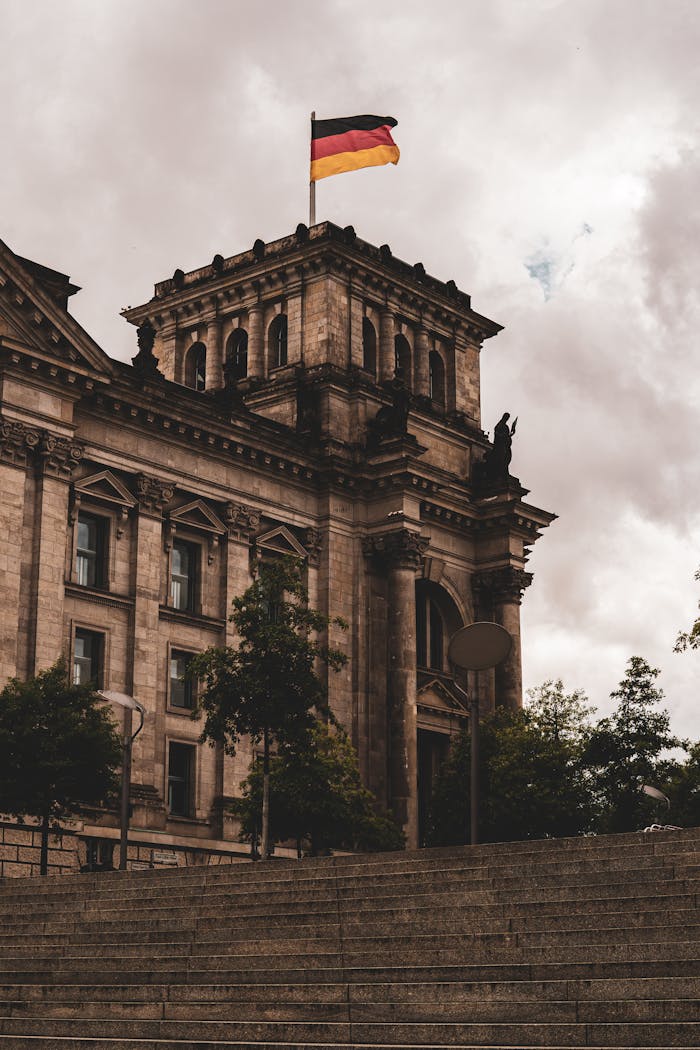 Crafting Captivating Headlines: Your awesome post title goes here View of the historic Reichstag building in Berlin, Germany, featuring Renaissance architecture and the German flag waving above.