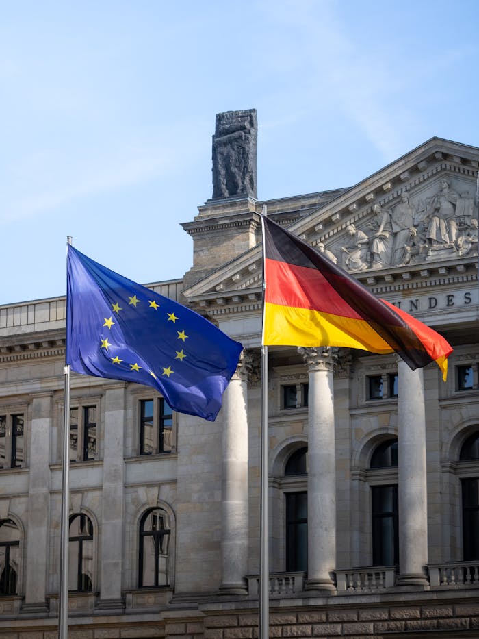 The Art of Drawing Readers In: Your attractive post title goes here Flags of Germany and the European Union waving in front of the Bundestag building in Berlin, Germany.
